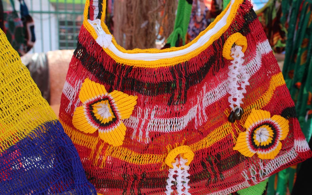 Colourful bilum hanging in a market stall